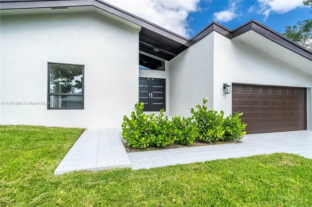 a view of a livingroom with wooden floor and white walls