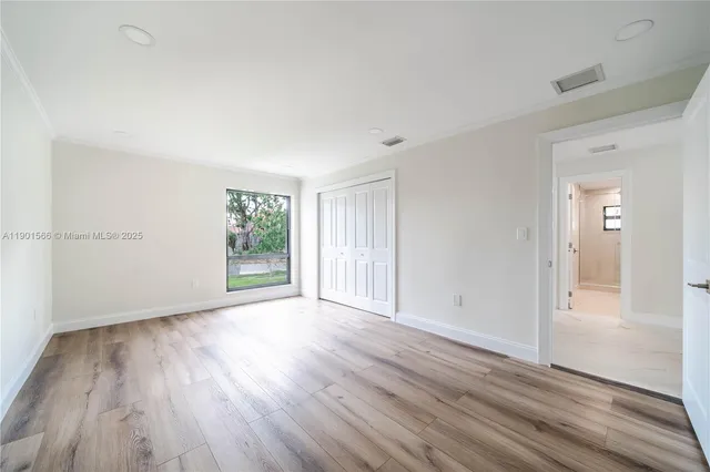 an aerial view of a house with a yard and lake view