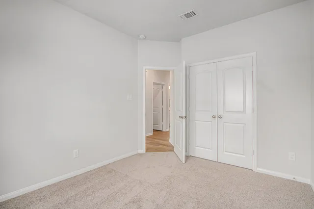 a view of an empty room and closet area