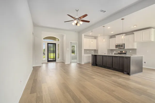 a view of kitchen with cabinets and wooden floor