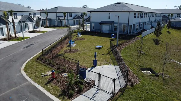 a view of a house with backyard and sitting area