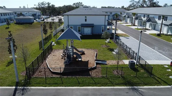 an aerial view of a house with swimming pool garden and patio