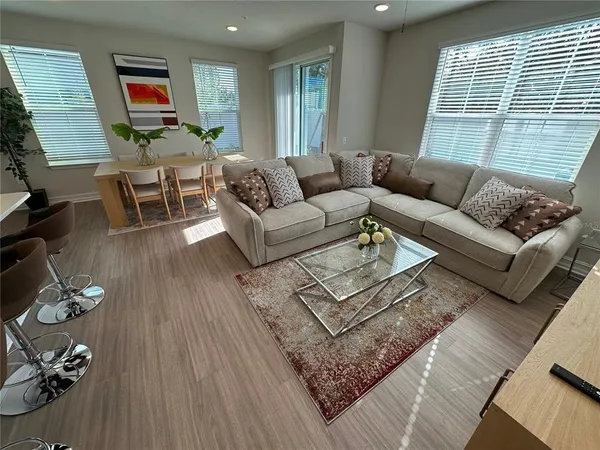 a living room with furniture and wooden floor