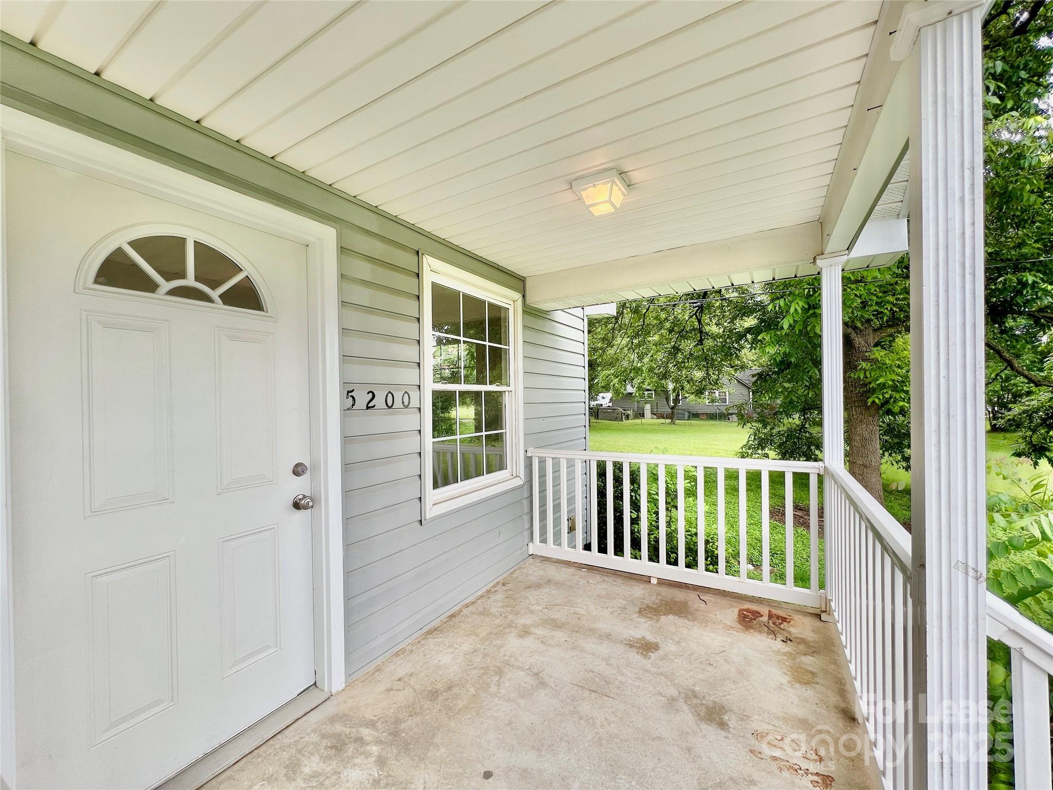 a view of porch with a small yard