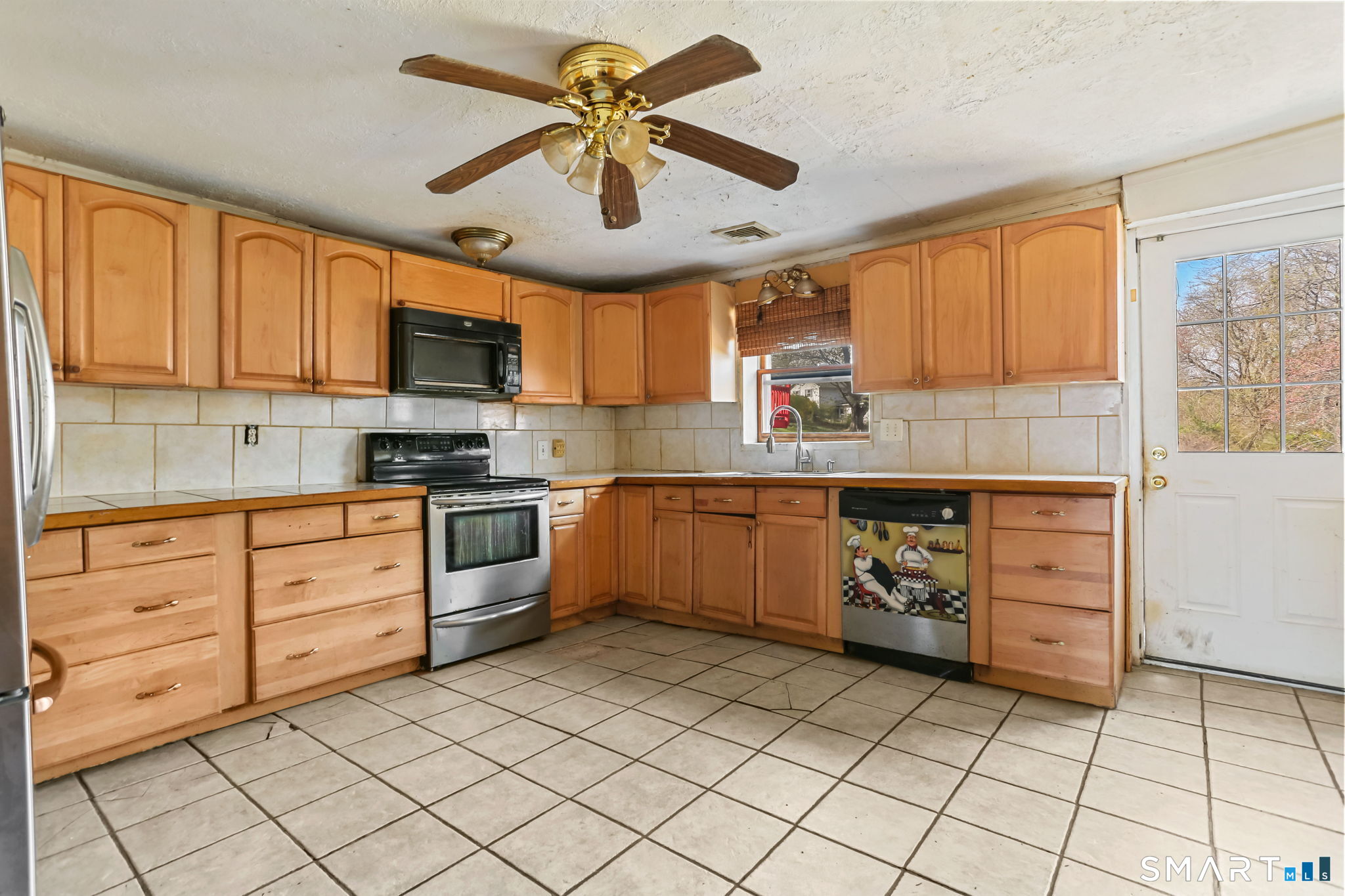39 Soundview Avenue Milford, CT 06460 - Photo 8 of 18 a kitchen with cabinets stainless steel appliances and a window