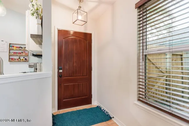 a view of hallway with stairs and wooden floor