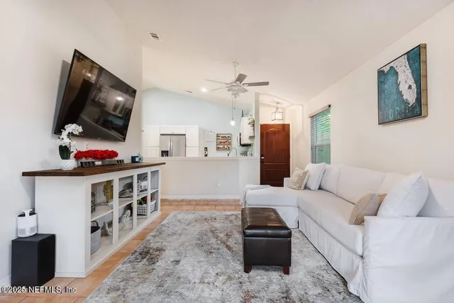 a living room with furniture and a flat screen tv