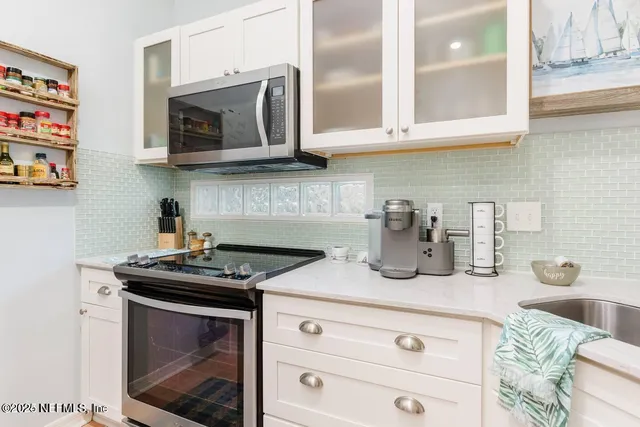 a kitchen with stainless steel appliances granite countertop a stove a microwave and cabinets