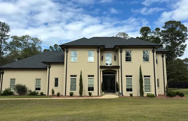 a front view of a house with a yard