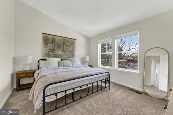 a bedroom with a bed lamp and window