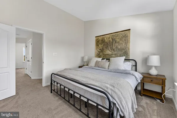 a bedroom with a bed and a lamp