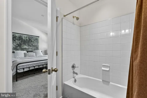 a bathroom with a bathtub and a shower