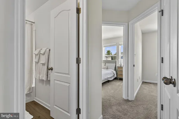 a bathroom with a sink a toilet a mirror and shower curtain