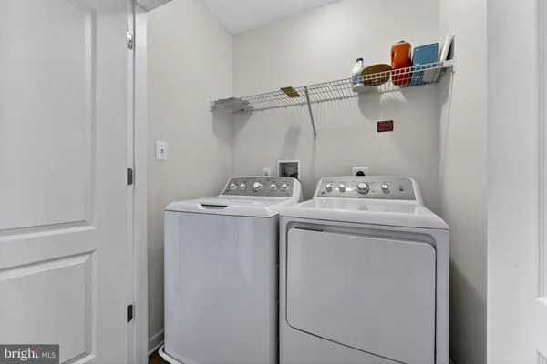 a view of a hallway with wooden floor and entryway