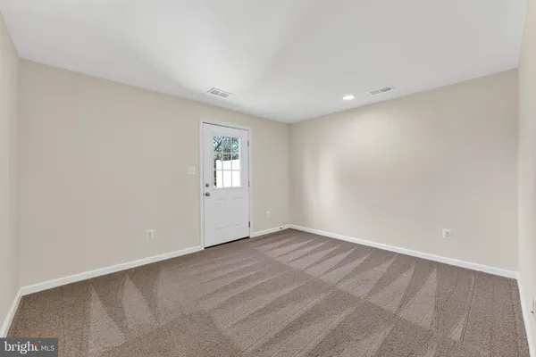 an empty room with entrance and windows