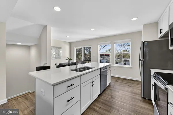 a kitchen with a sink stove and refrigerator