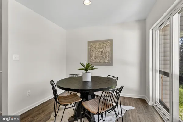 a dining room with furniture and wooden floor