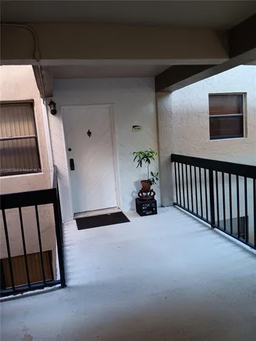 a view of an empty room with windows