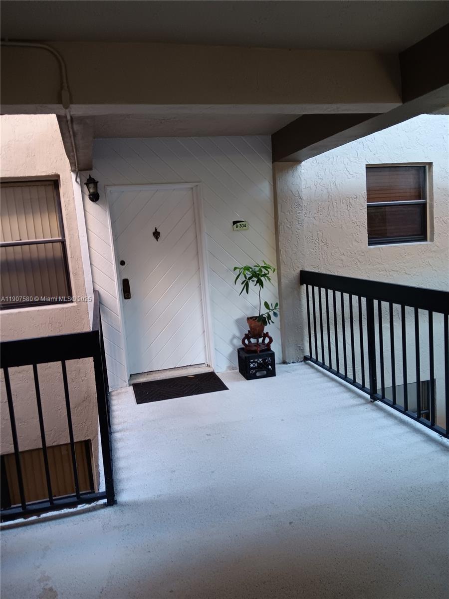 461 Ives Dairy Road, Unit 3042 Miami, FL 33179 - Photo 2 of 2 a view of an empty room with windows