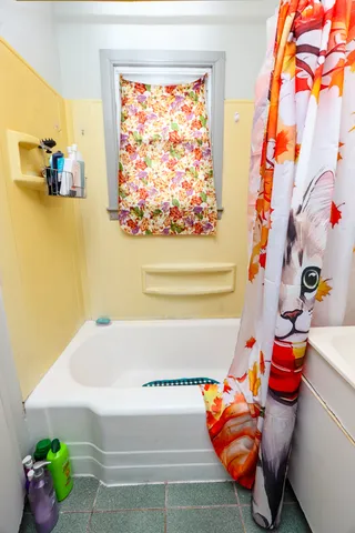 a kids bedroom with a bed and a window