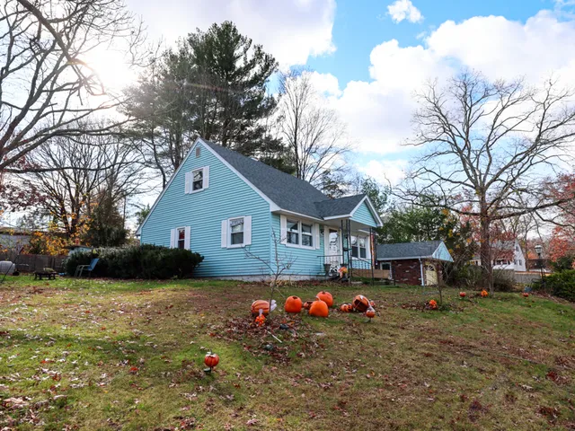 a view of a house with a yard covered in snow