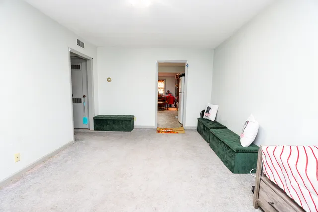 a view of a livingroom with an empty space and a hallway