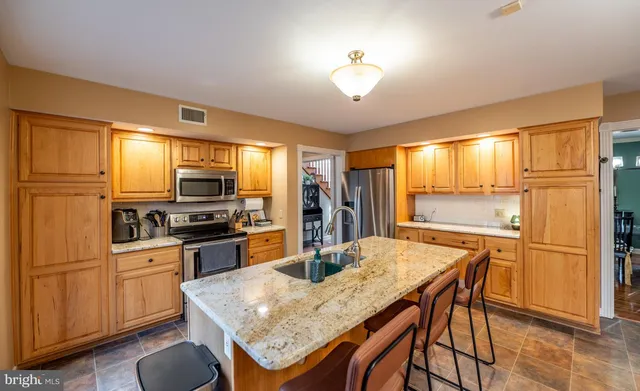 a living room with furniture a flat screen tv and a floor to ceiling window