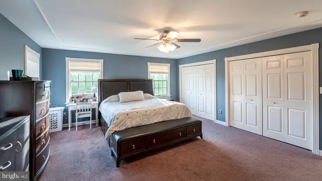 a en suite bathroom with a granite countertop tub sink a mirror and shower