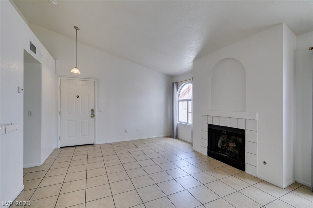 7570 West Flamingo Road, Unit 252 Las Vegas, NV 89147 - Photo 8 of 44 A welcoming entry, with a classic fireplace and tiled flooring, creates a comfortable living space.