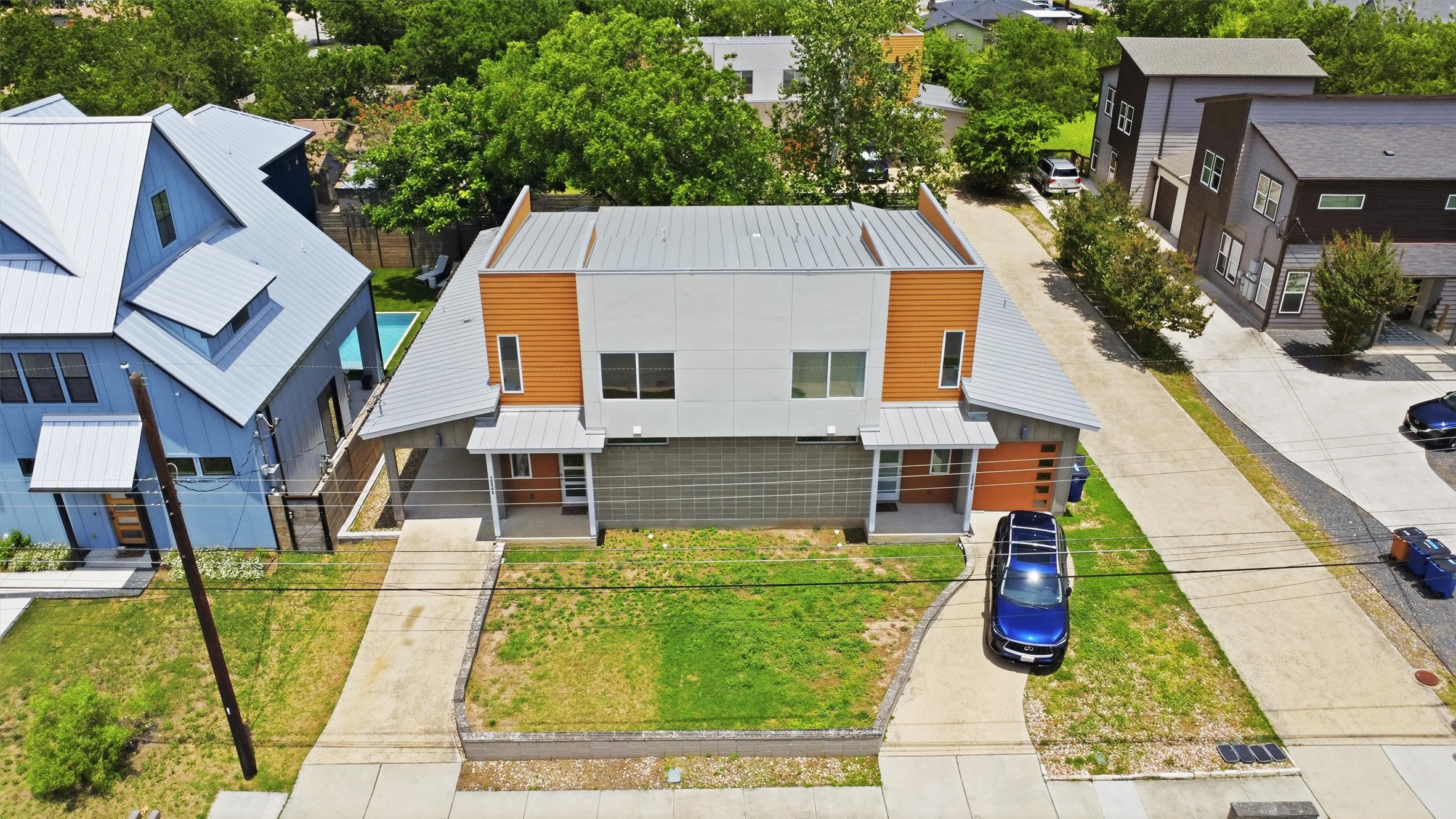 1210 Stobaugh Street, Unit B Austin, TX 78757 - Photo 37 of 40 Modern townhomes showcasing sleek metal roofs and clean lines, offering contemporary living.