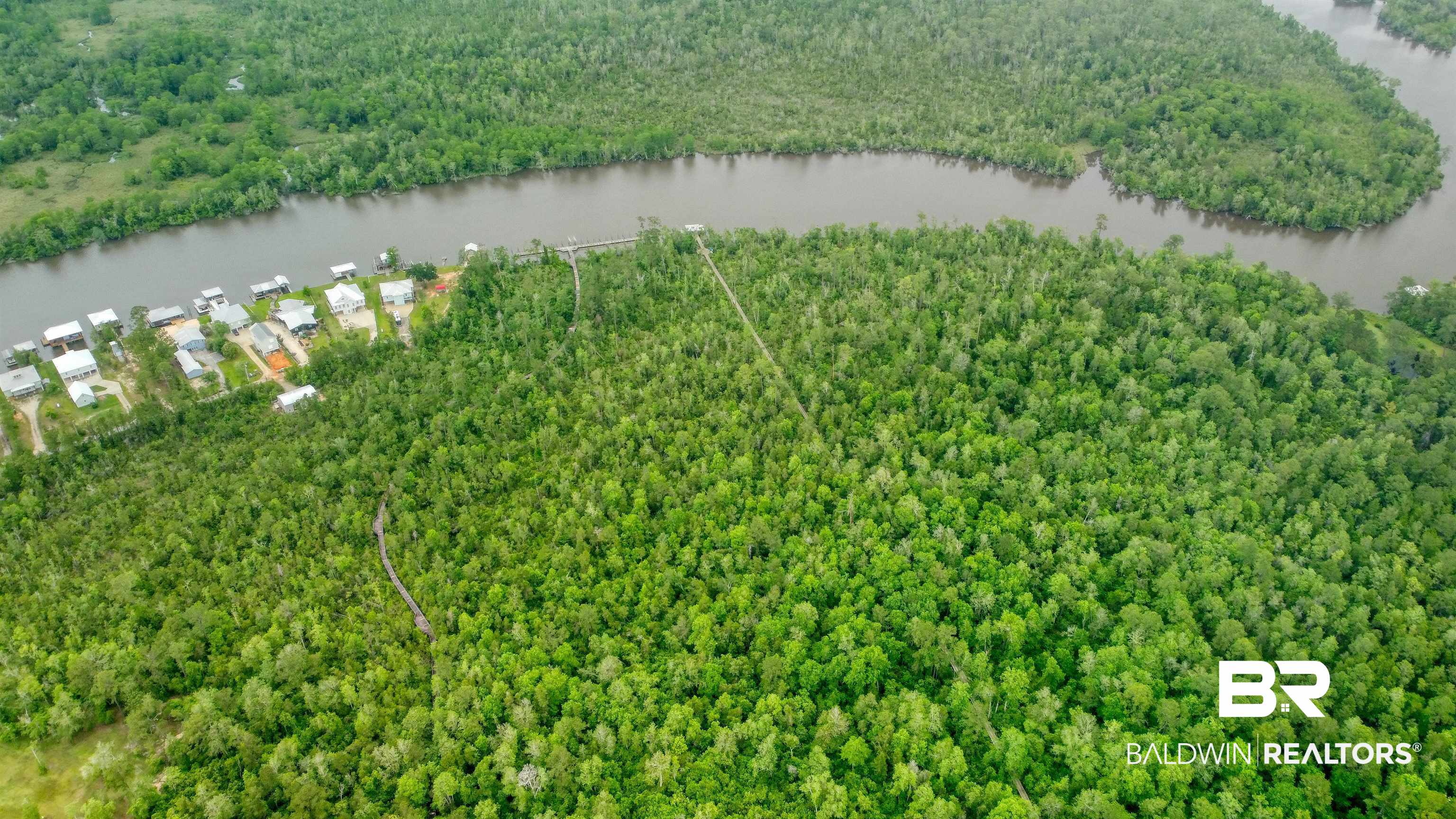 Pandion Drive Foley, AL 36535 - Photo 5 of 9 Drone / aerial view of a nearby body of water and a heavily wooded area