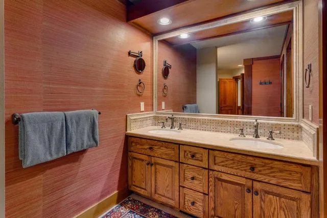 a bathroom with a double vanity sink and a mirror