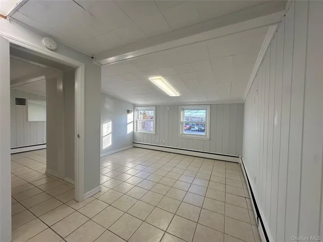 an empty room with windows and closet