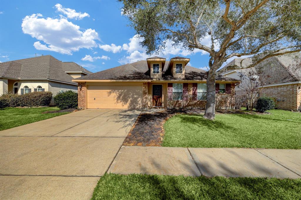 6103 Hubbell Drive Pearland, TX 77584 - Photo 1 of 33 a front view of a house with garden
