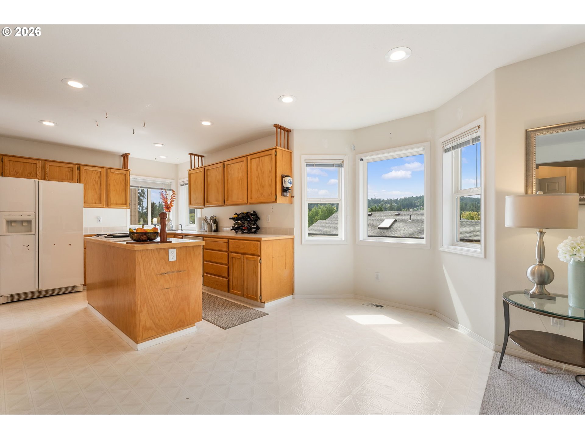 8943 Southwest 149th Place Beaverton, OR 97007 - Photo 13 of 41 a kitchen with sink refrigerator and cabinets