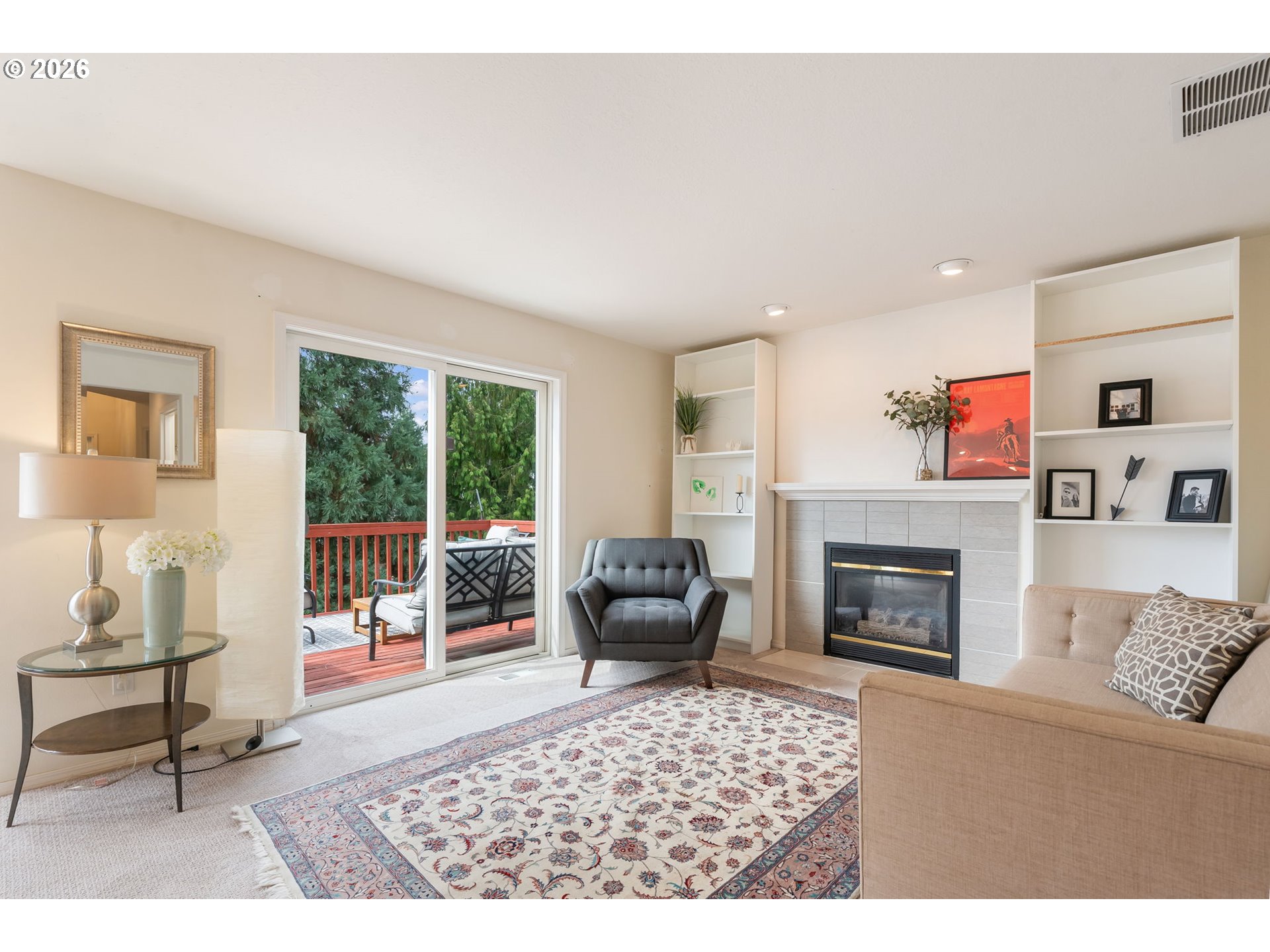 8943 Southwest 149th Place Beaverton, OR 97007 - Photo 15 of 41 a living room with furniture a flat screen tv and a fireplace