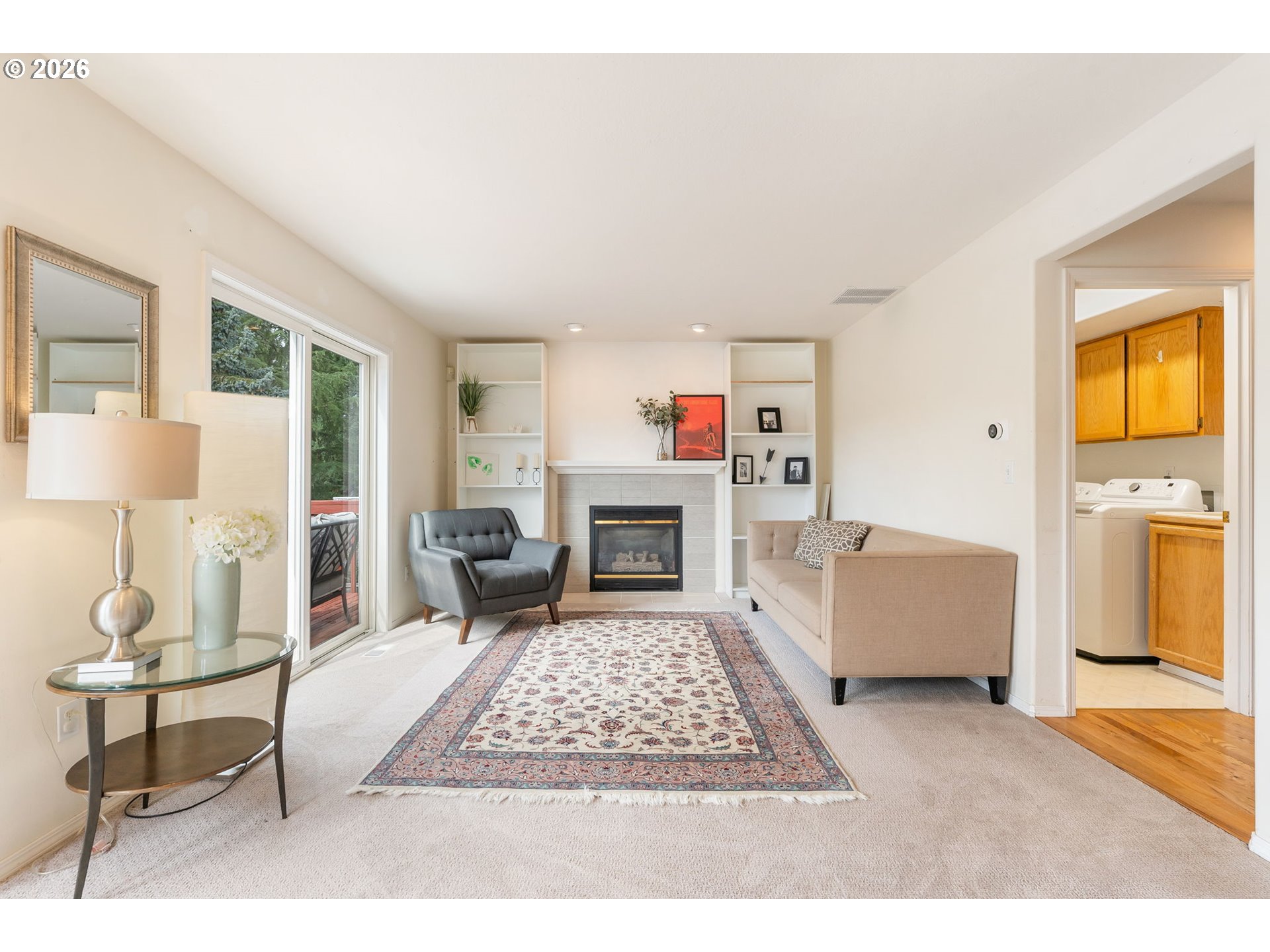 8943 Southwest 149th Place Beaverton, OR 97007 - Photo 16 of 41 a living room with furniture a rug and a fireplace