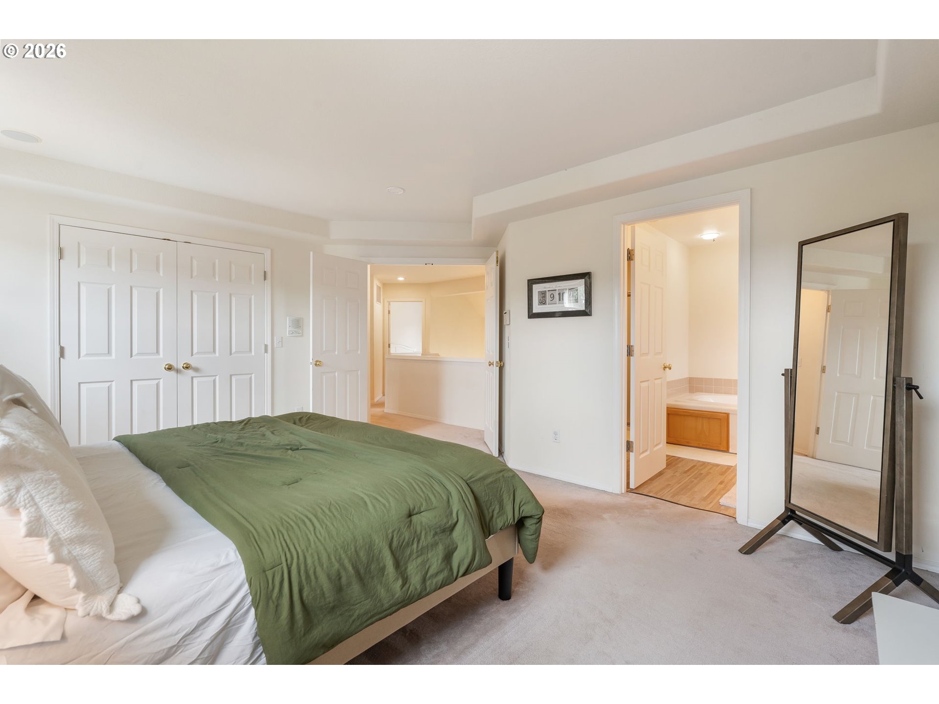 8943 Southwest 149th Place Beaverton, OR 97007 - Photo 24 of 41 a bedroom with a bed and a chandelier