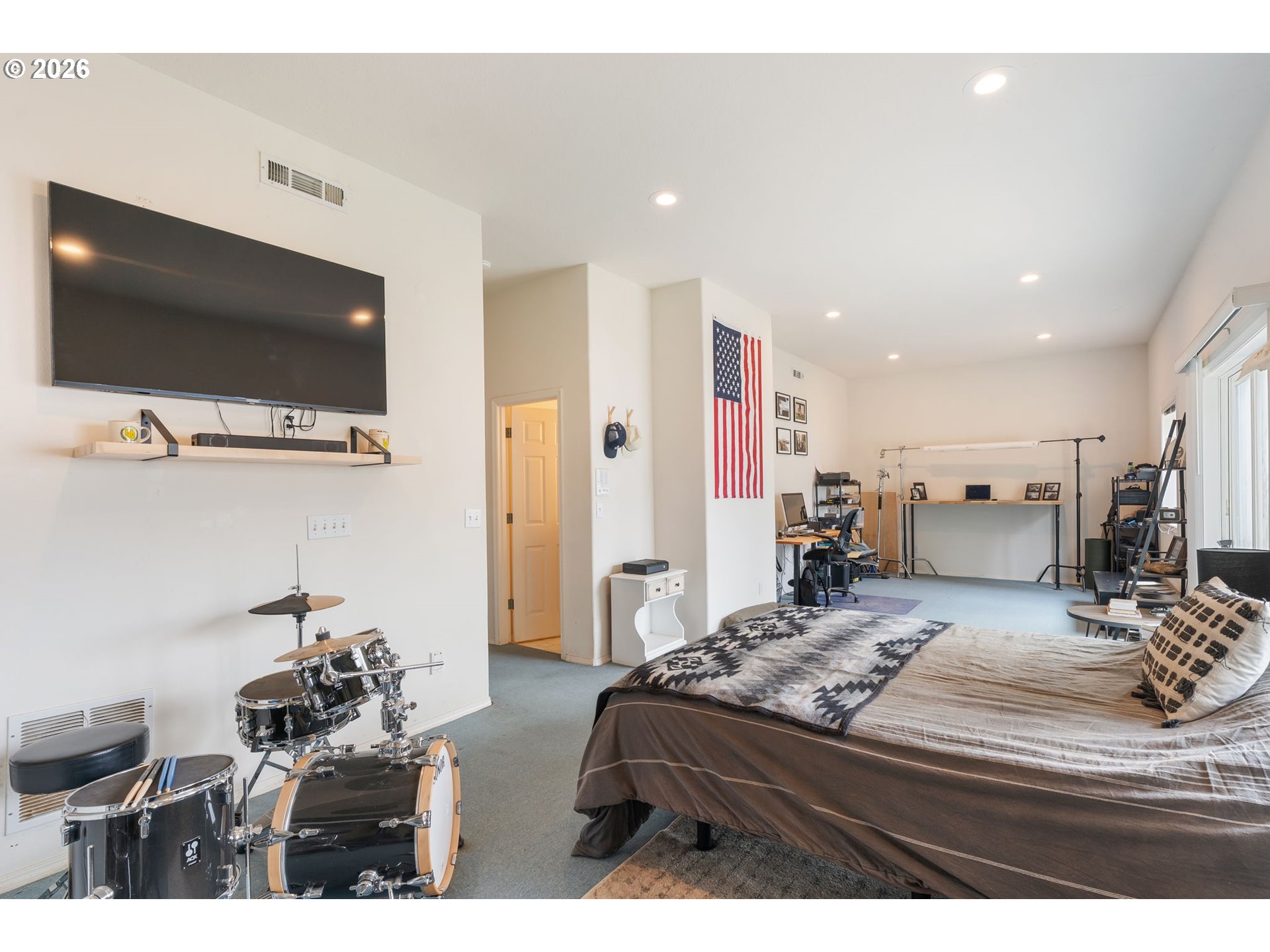 8943 Southwest 149th Place Beaverton, OR 97007 - Photo 32 of 41 a bedroom with a bed and a flat screen tv