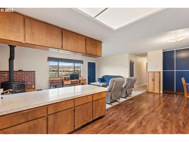 a kitchen with stainless steel appliances kitchen island granite countertop a sink and cabinets