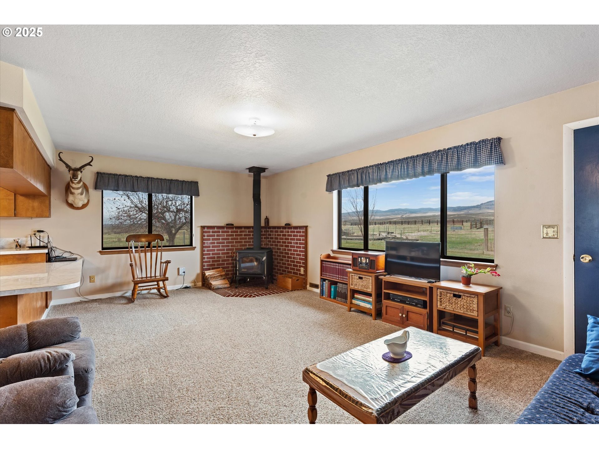 27877 Skinner Road Baker City, OR 97814 - Photo 18 of 48 a living room with furniture a pool table and a large window