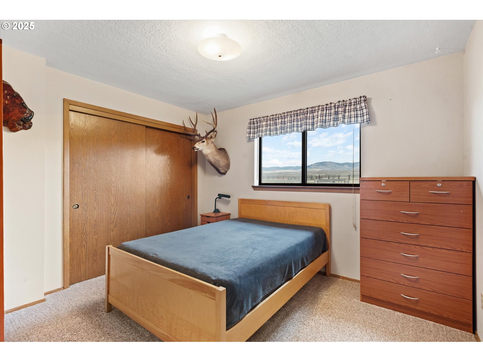 27877 Skinner Road Baker City, OR 97814 - Photo 20 of 48 a bedroom with a bed and a window