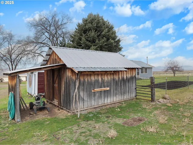a backyard of a house with bicycles parked and swing