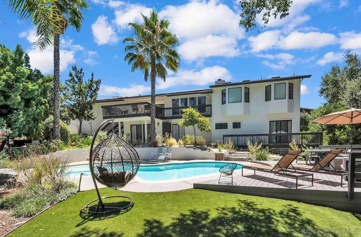 3550 Laketree Drive Fallbrook, CA 92028 - Photo 1 of 56 a front view of a house with swimming pool table and chairs