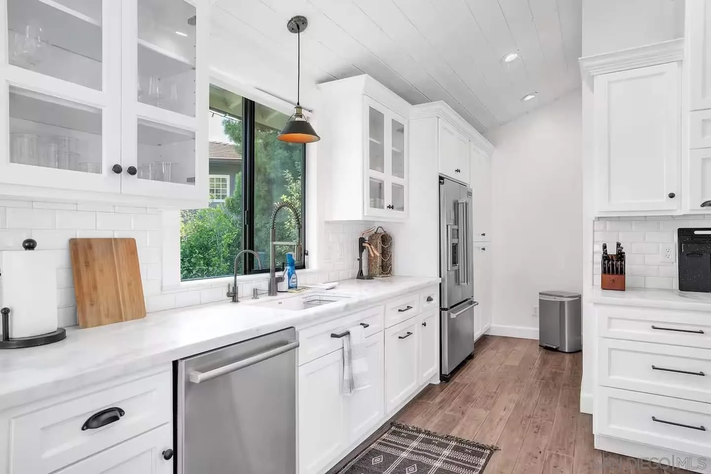 3550 Laketree Drive Fallbrook, CA 92028 - Photo 12 of 56 a kitchen with stainless steel appliances kitchen island granite countertop a sink and a refrigerator