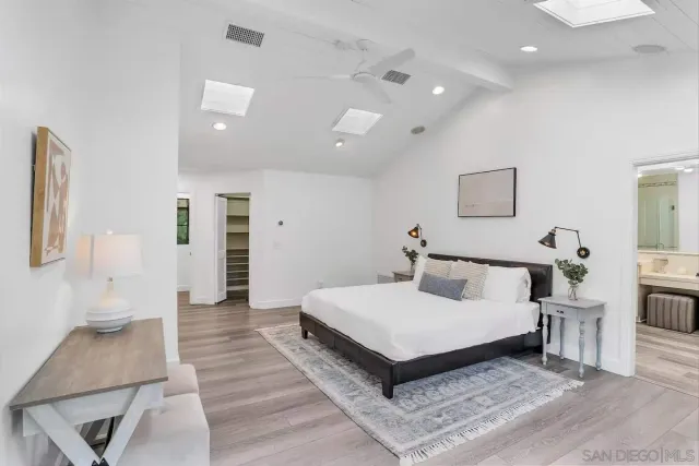 a bedroom with a bed and a table