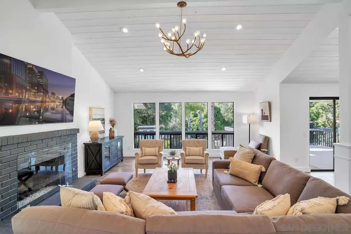 3550 Laketree Drive Fallbrook, CA 92028 - Photo 2 of 56 a living room with furniture fireplace and large windows