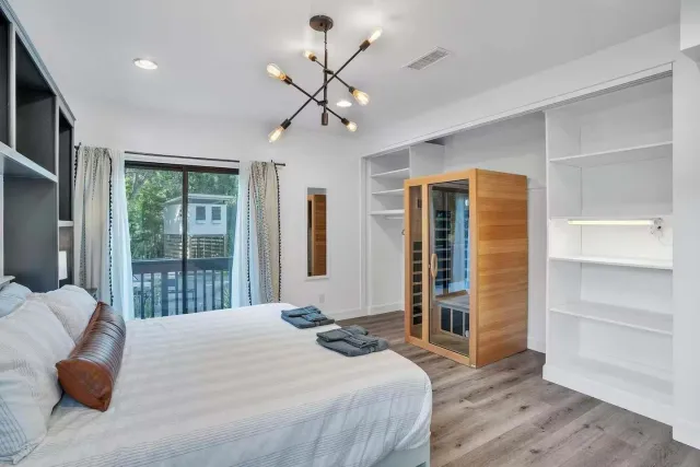 a bedroom with a bed and lamps