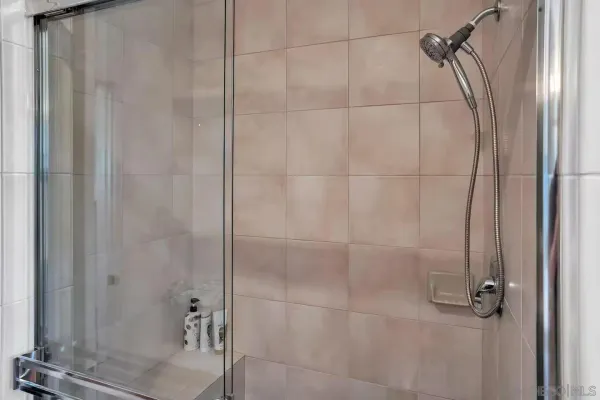 a bathroom with a double vanity sink mirror and shower