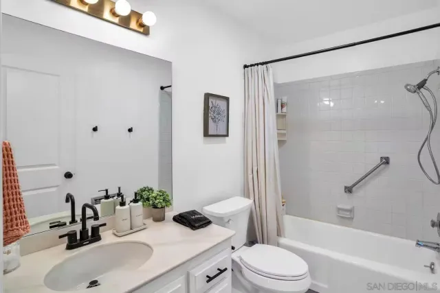 a bathroom with a sink toilet and mirror